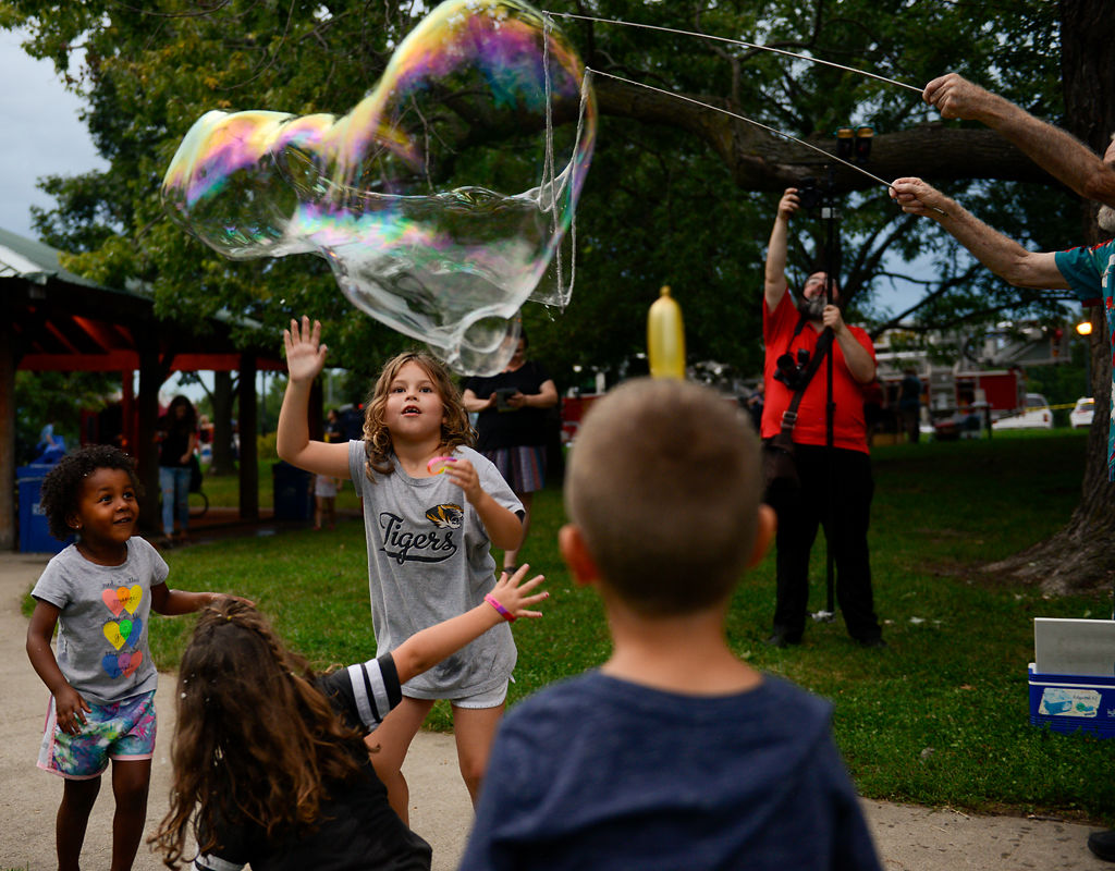 Kendyl Stephens-Kent, 4, left, and Olivia Johnson, 7, join a group